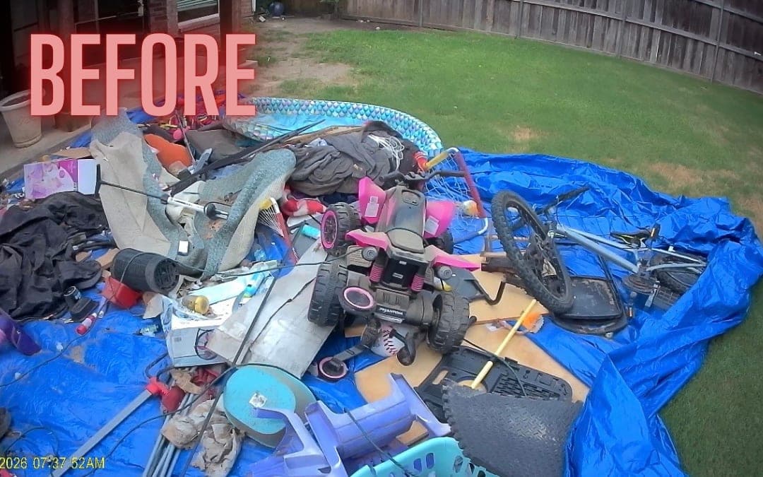 Before: toys and scrap piled on a tarp in a backyard