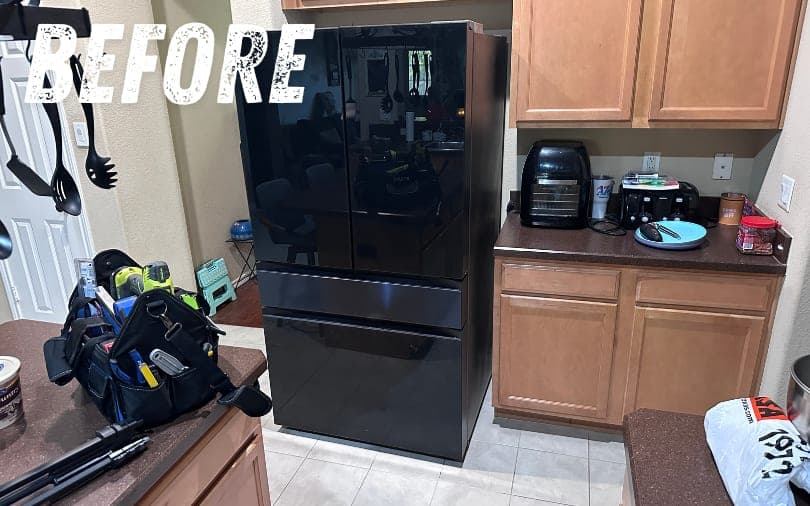 Before: a black refrigerator in a kitchen
