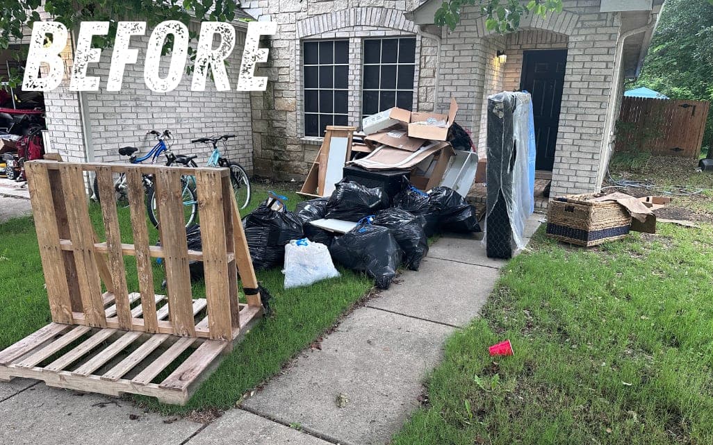 Before: pallets, trash bags and boxes in a front yard