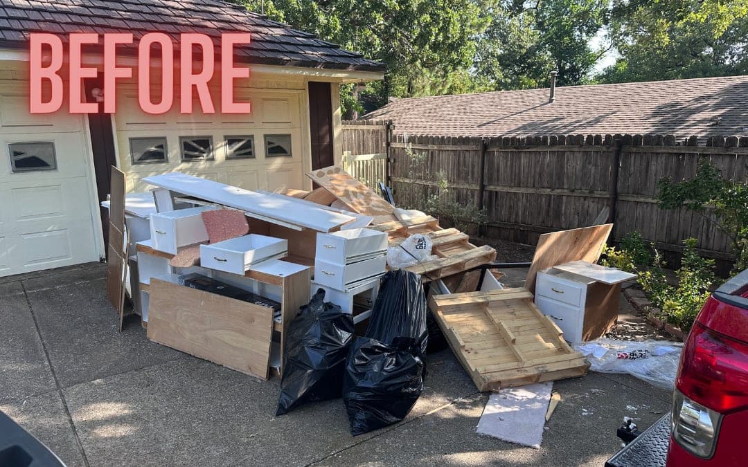 Before: boxes, cabinets and trash bags piled on a driveway